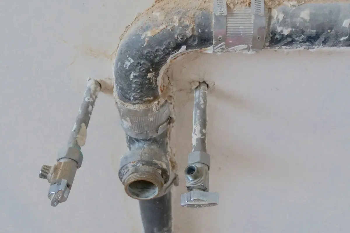 Plumbing pipework running into a wall